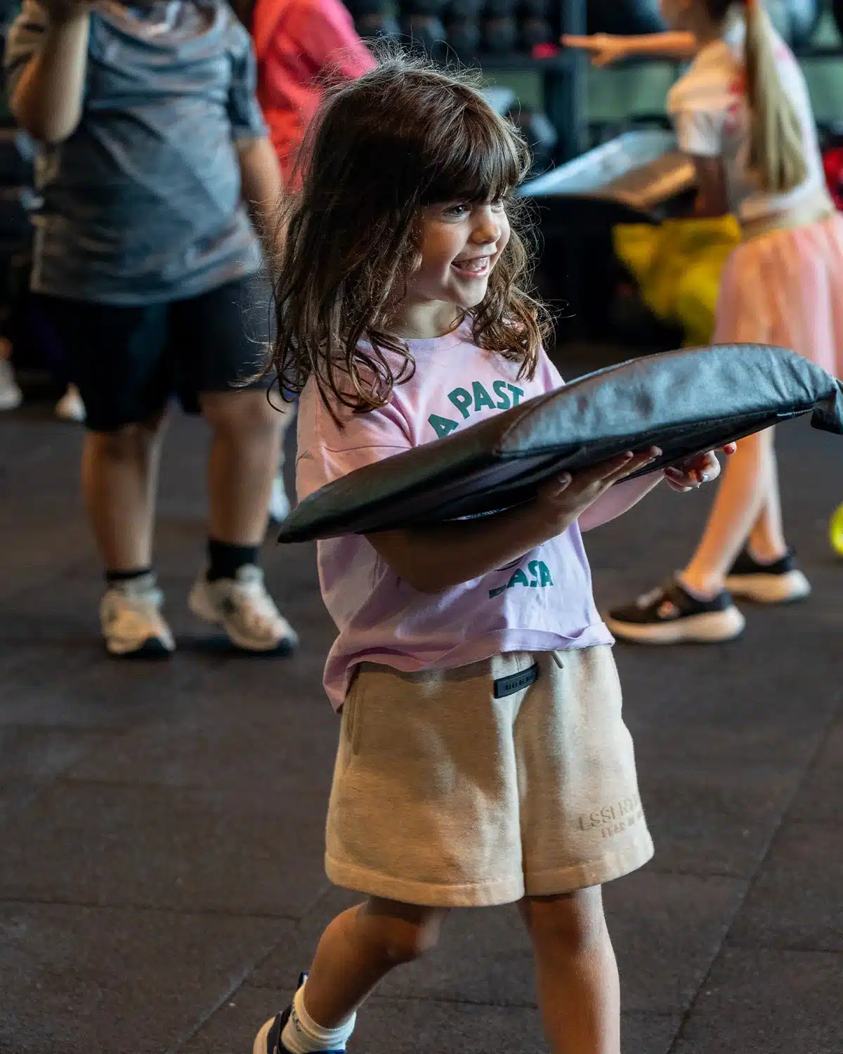 Young child carrying a training pad