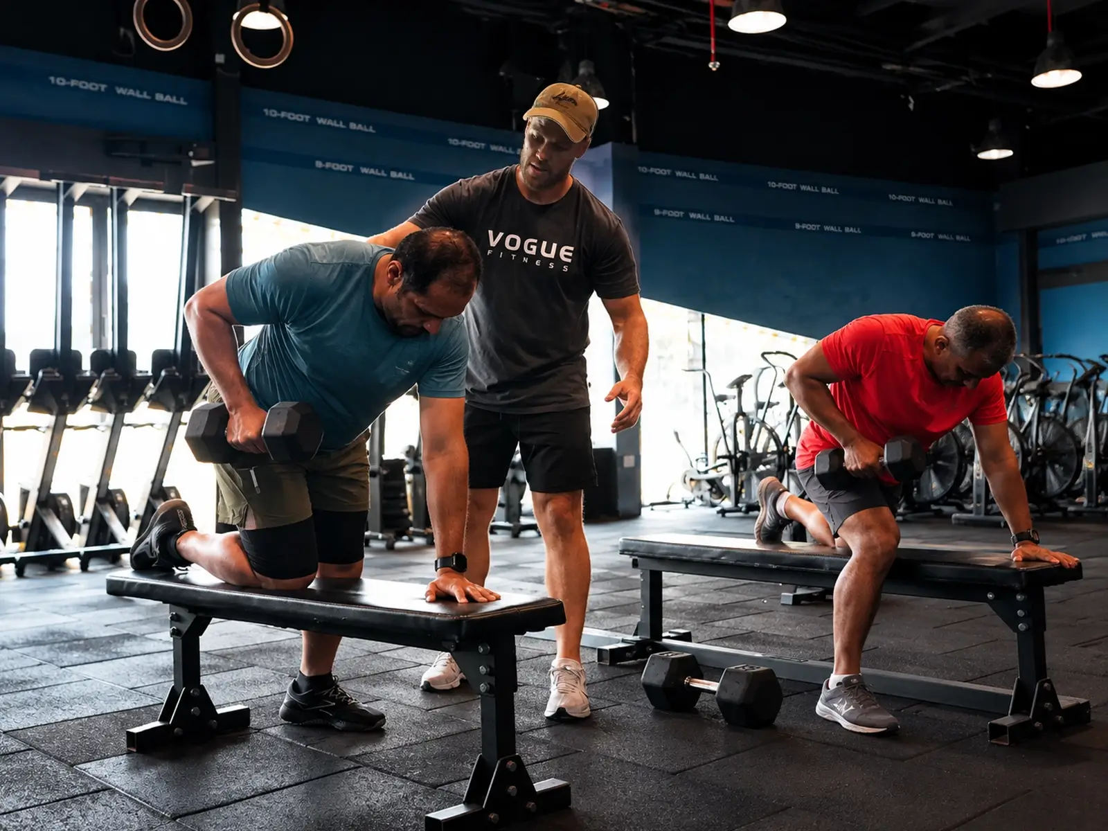 Vogue Fitness coach guiding two members through a duo personal training session